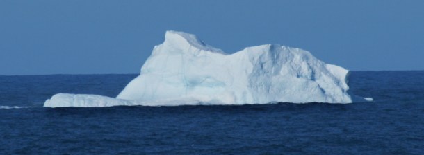 An iceberg drifting along in spring.
