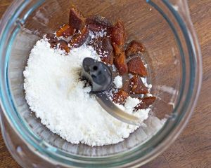 Grinding shredded coconut with dried apricots. Photo: Lisa Fuchs